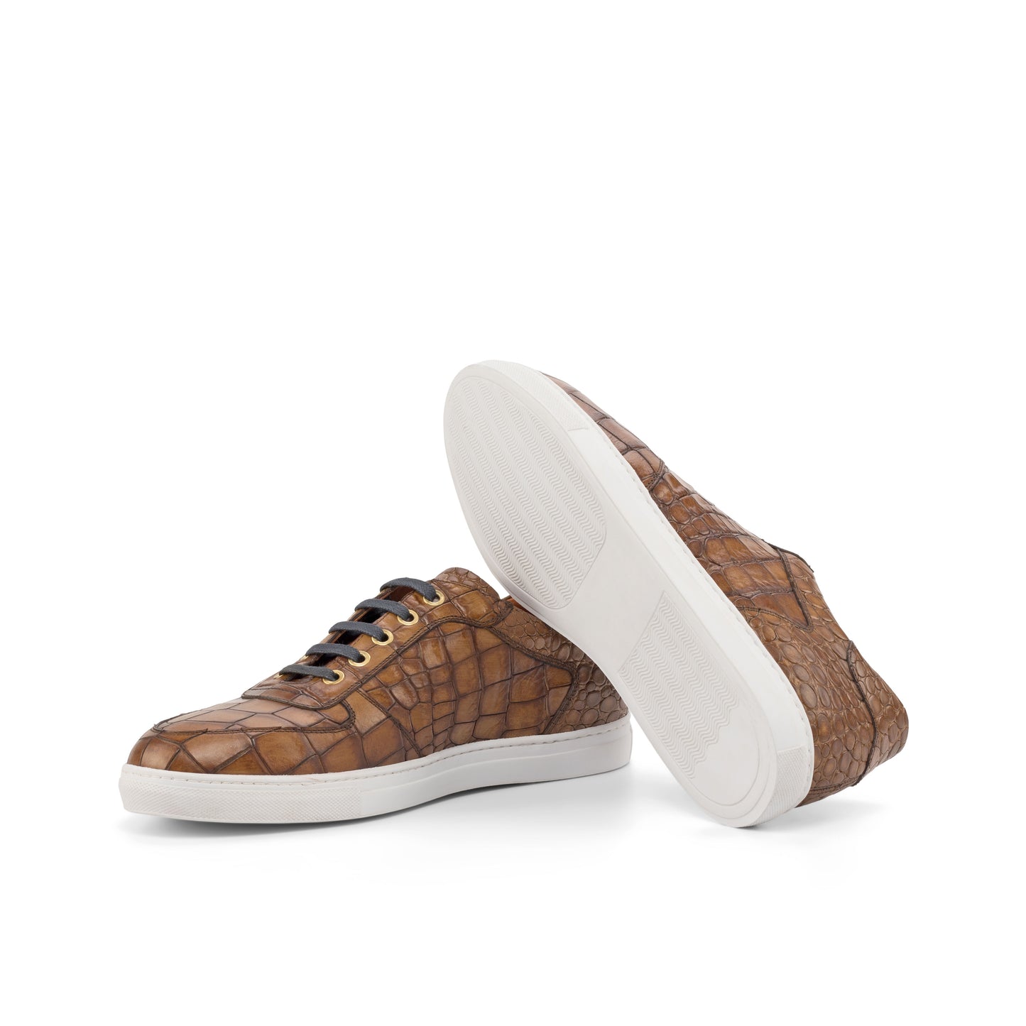 Brown patterned sneakers with white soles on a white background