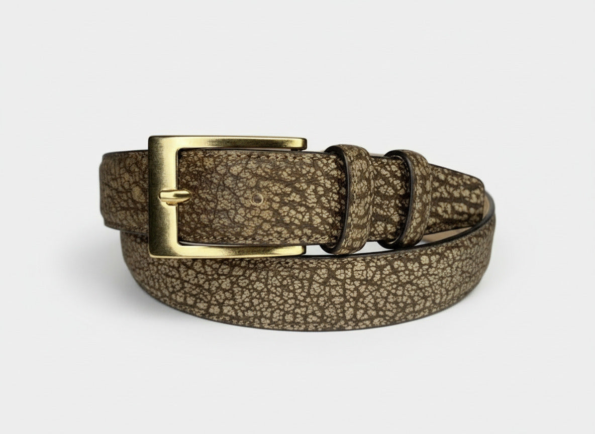 Gold buckle belt with a textured strap on a white background