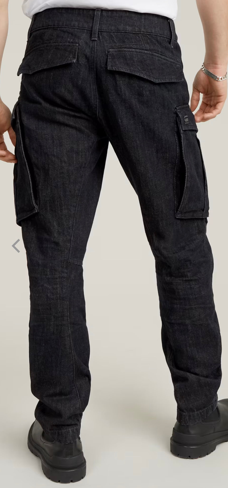 Black cargo pants worn by a person on a plain background