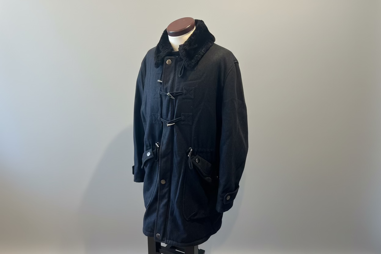 Dark coat on a mannequin against a neutral background