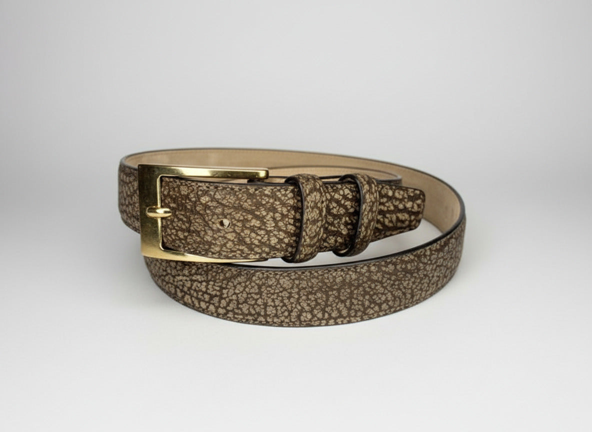 Brown leather belt with gold buckle on a white background