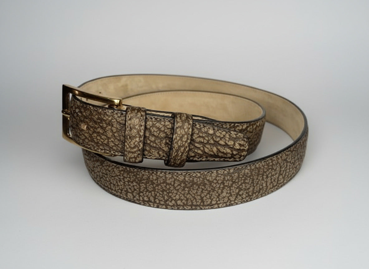 Brown textured belt with a gold buckle on a white surface