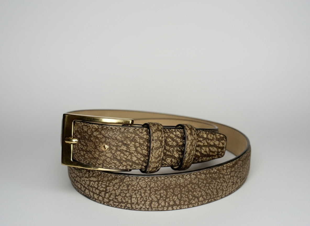 Brown textured belt with gold buckle on a white background