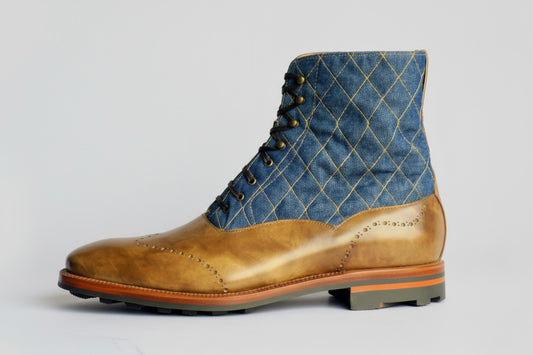 Brown leather boot with blue quilted pattern on a white background