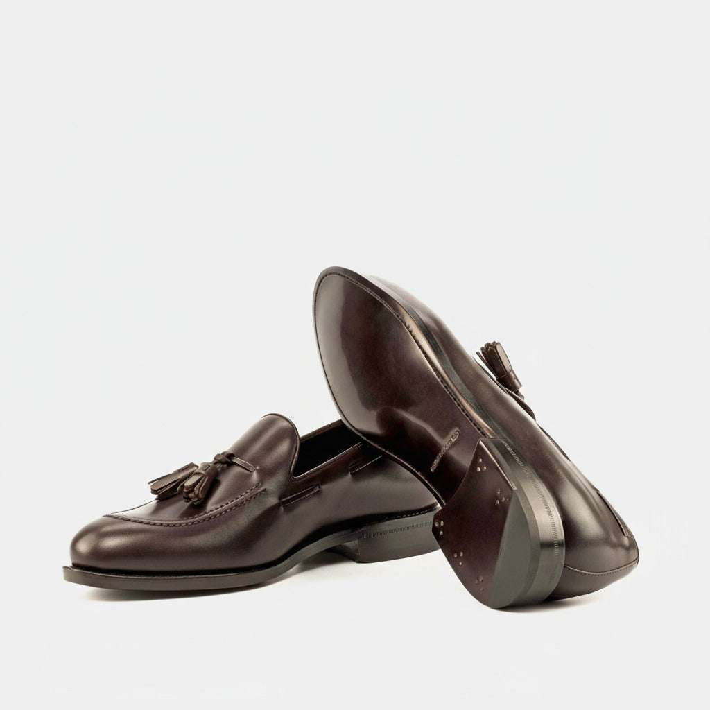 Pair of brown leather loafers on a white background