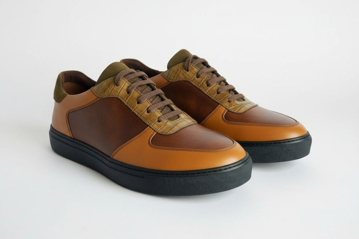 Pair of brown and tan leather sneakers on a white background