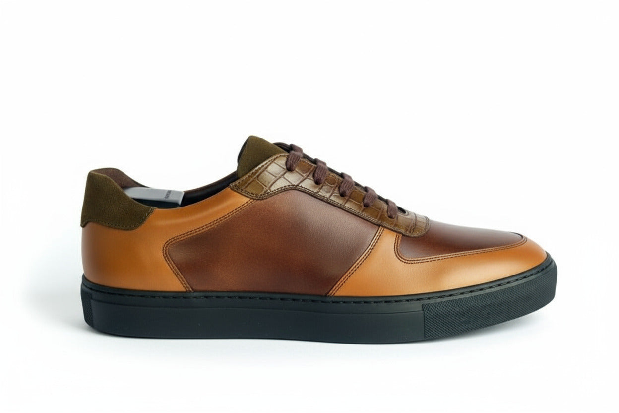 Brown leather sneaker with green accents on a white background