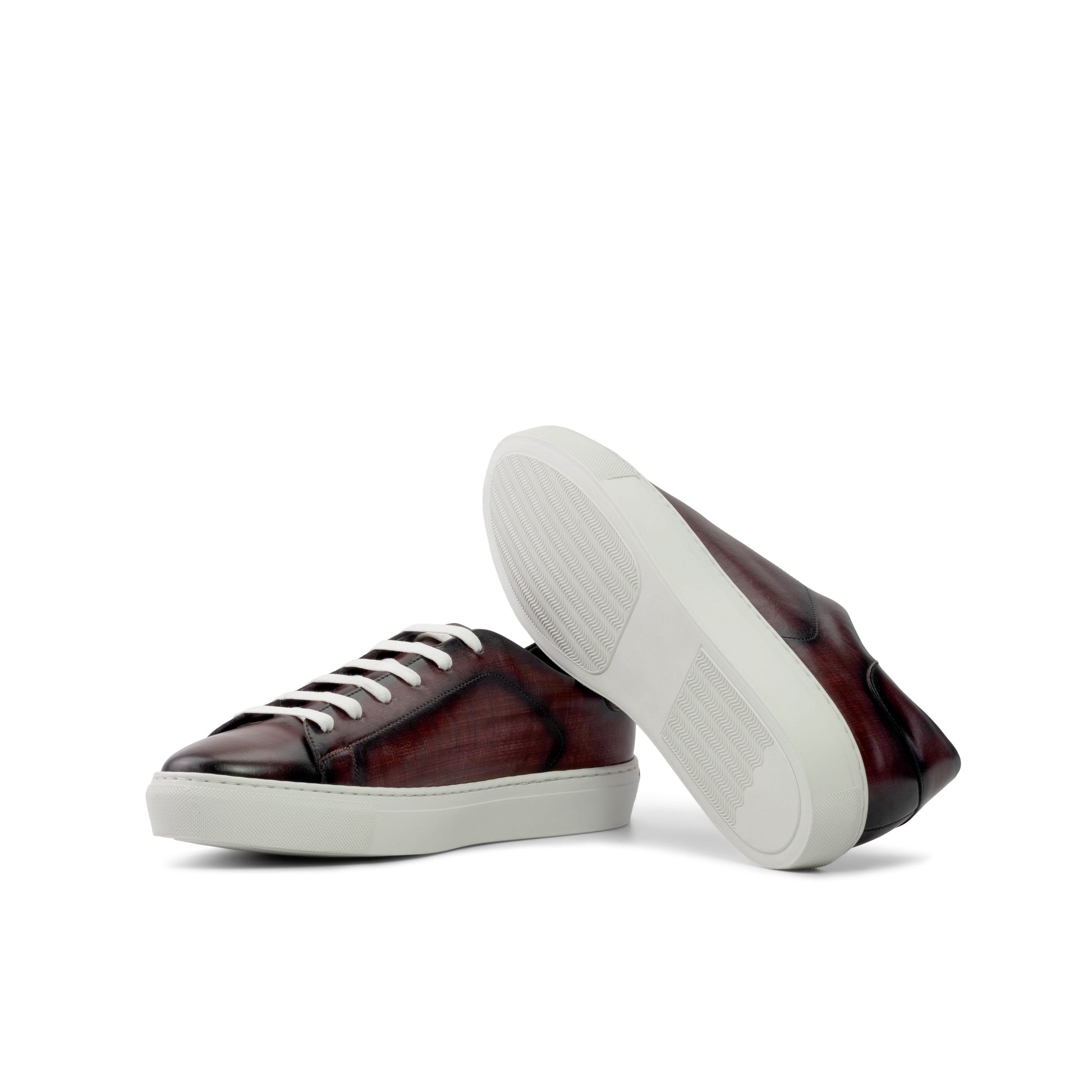 Brown sneakers with white soles on a white background