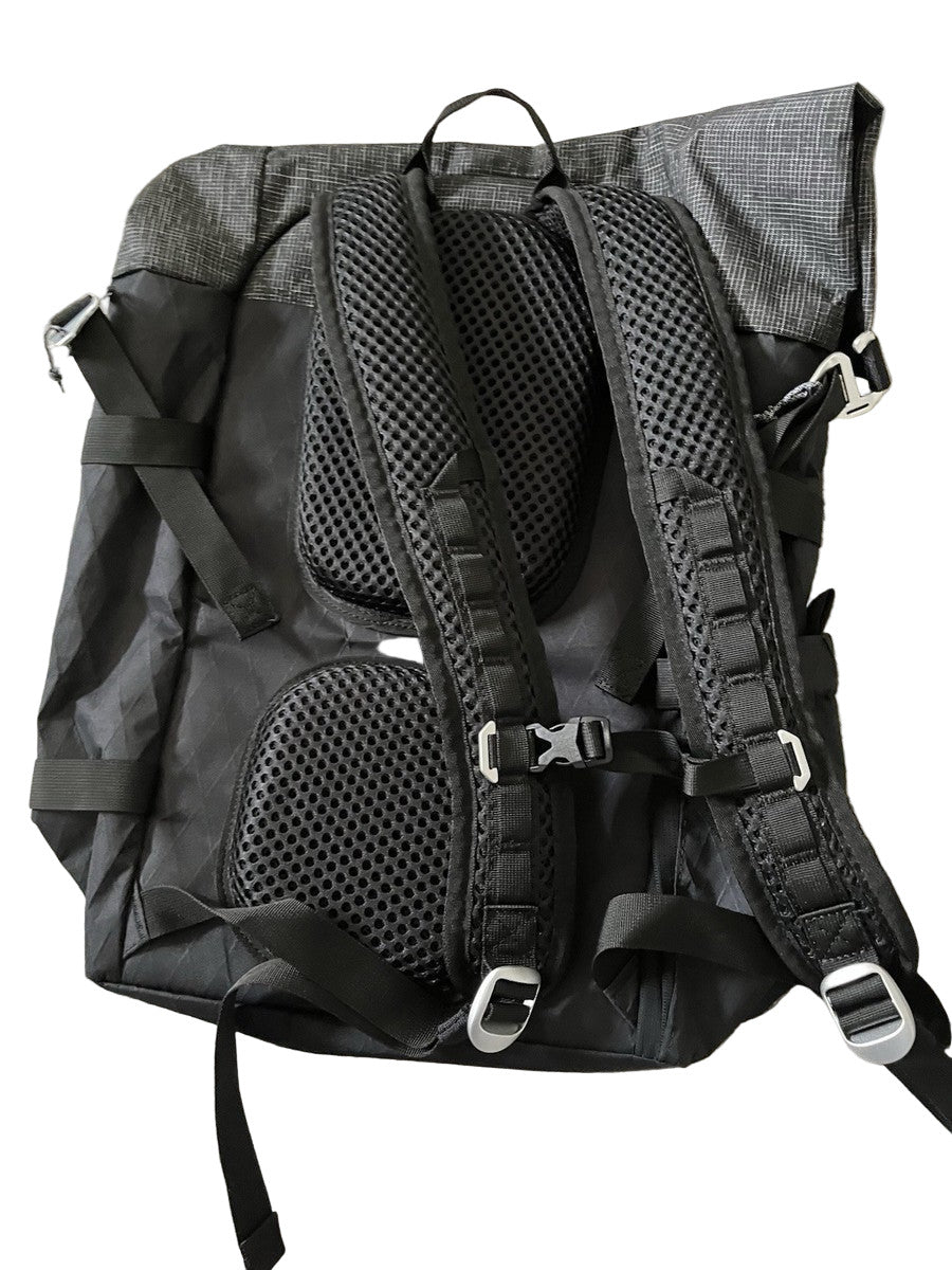 Black backpack with mesh padding on a textured surface
