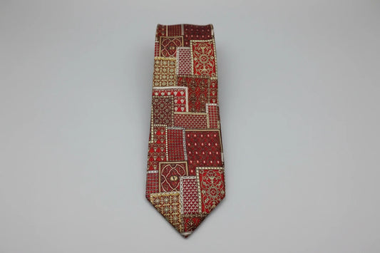 Red patterned tie on a reflective surface