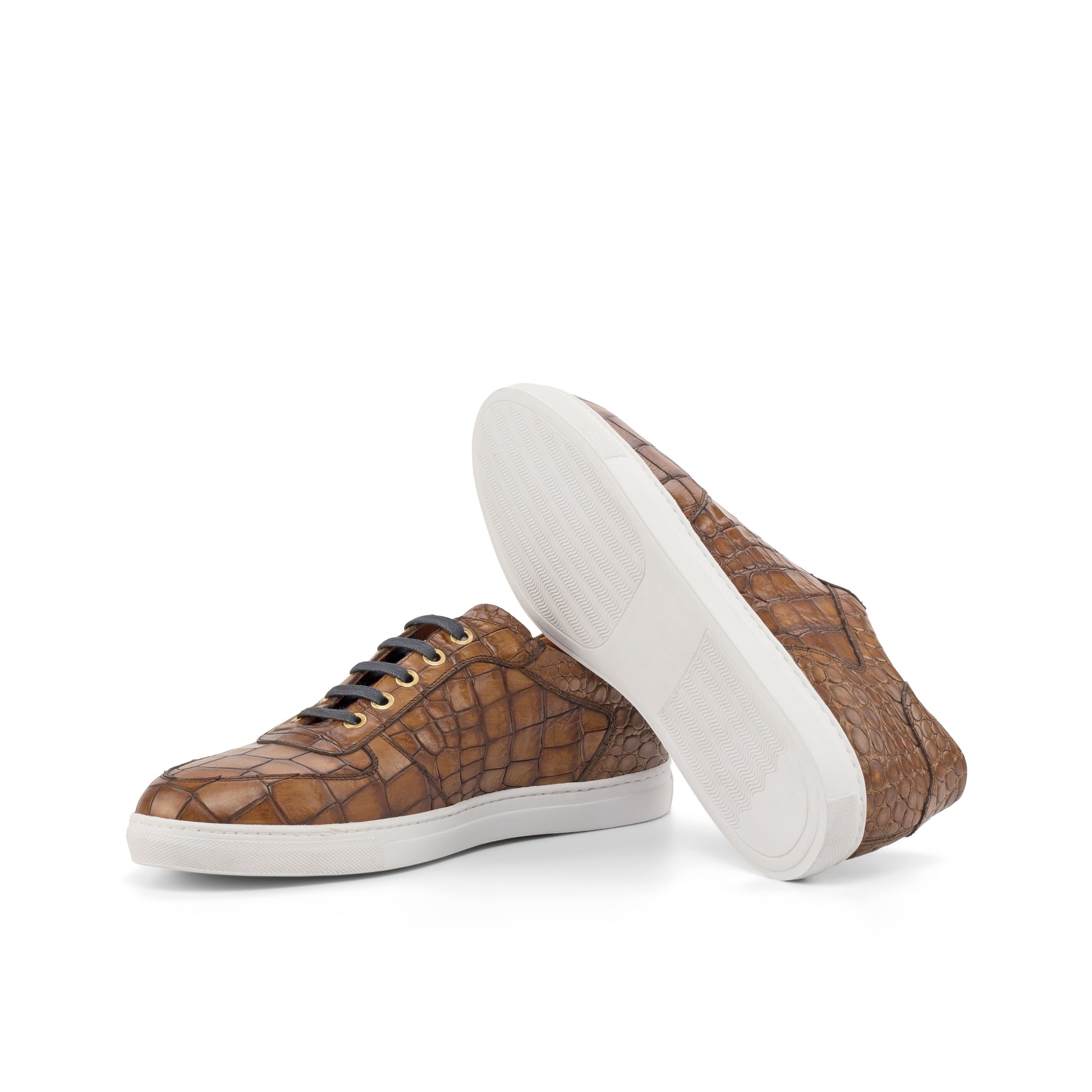 Brown patterned sneakers with white soles on a white background
